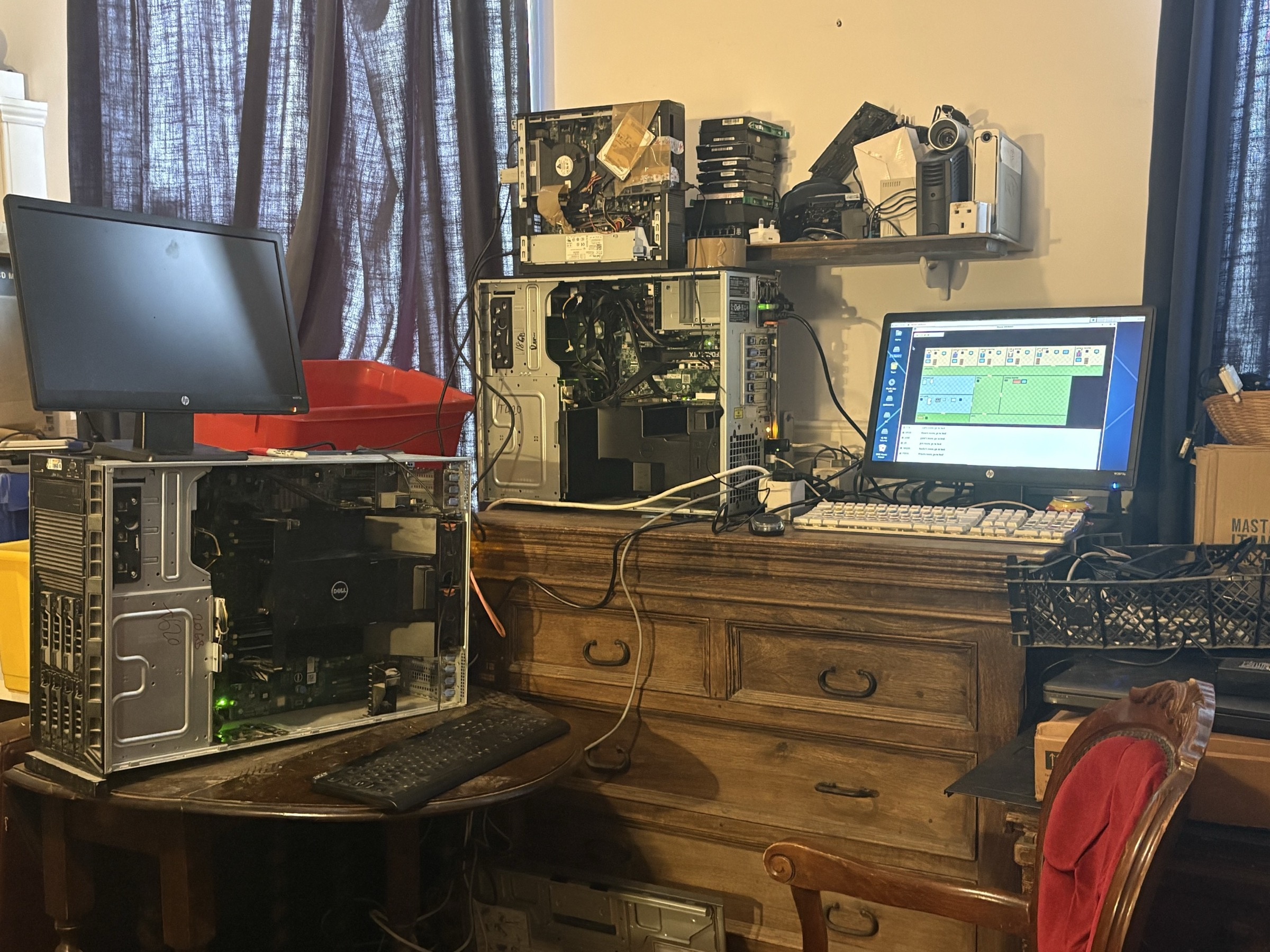 The actual early house setup, with opened older computers and the on-screen house.